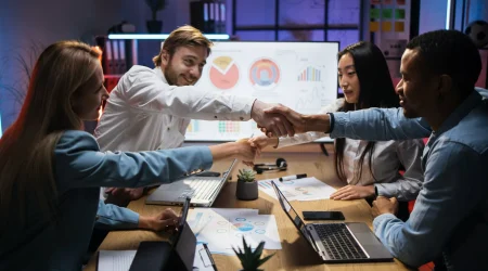 Multicultural partners shaking hands after meeting